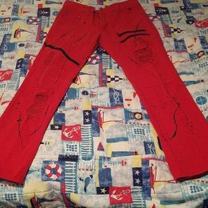 Red jeans with paint designs and zippers